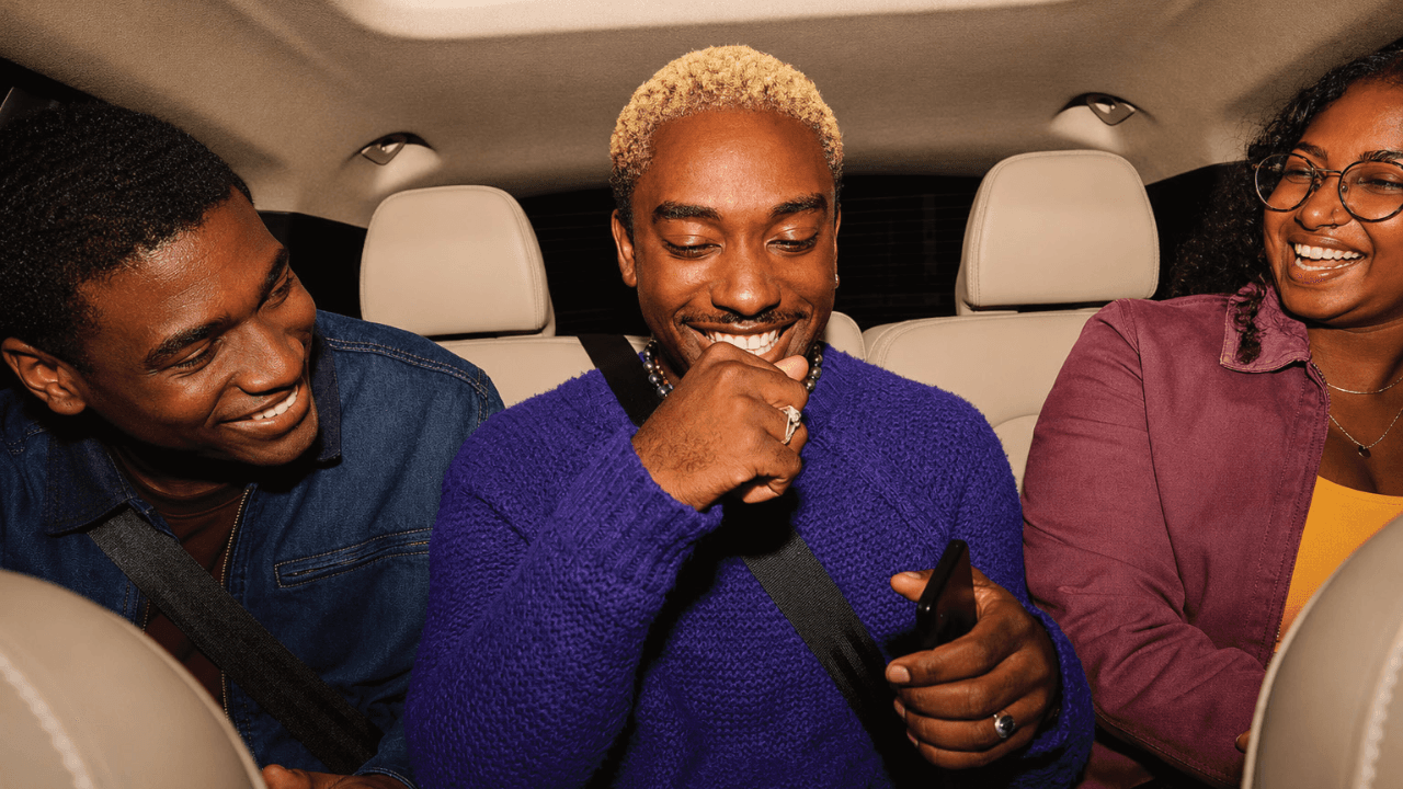Friends sharing a moment in the back seat of a car